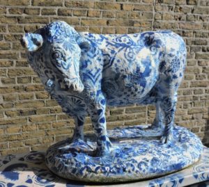 a Delft Blue cow in the city center of Delft